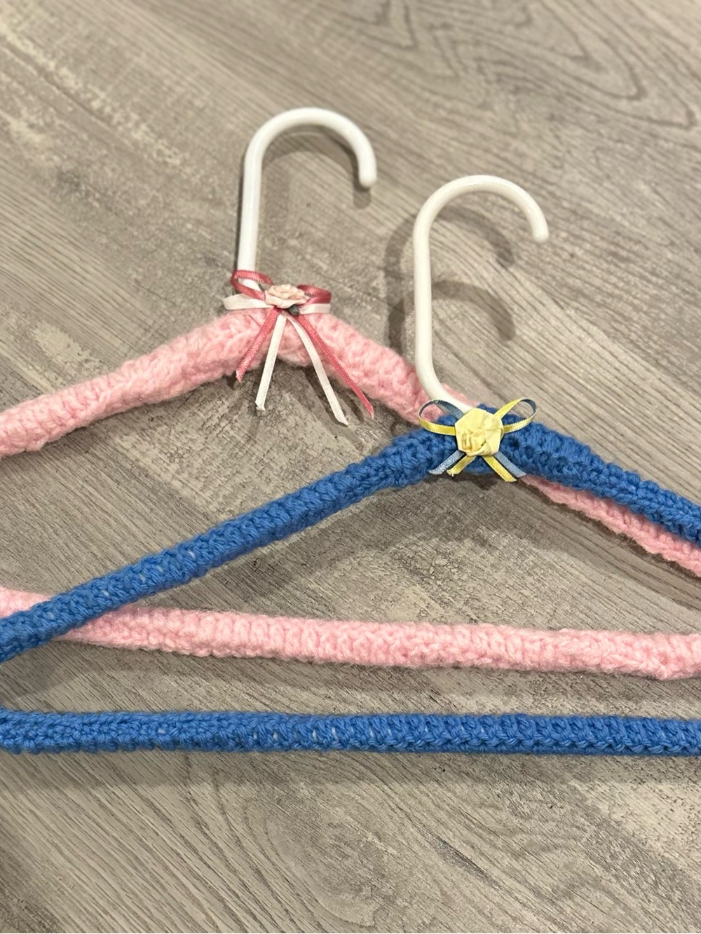 Handmade Pink and Blue Yarn-Covered Closet Hangers with Decorative Bows